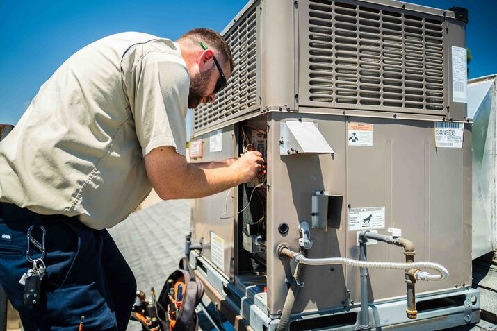 contractor repairing air conditioner